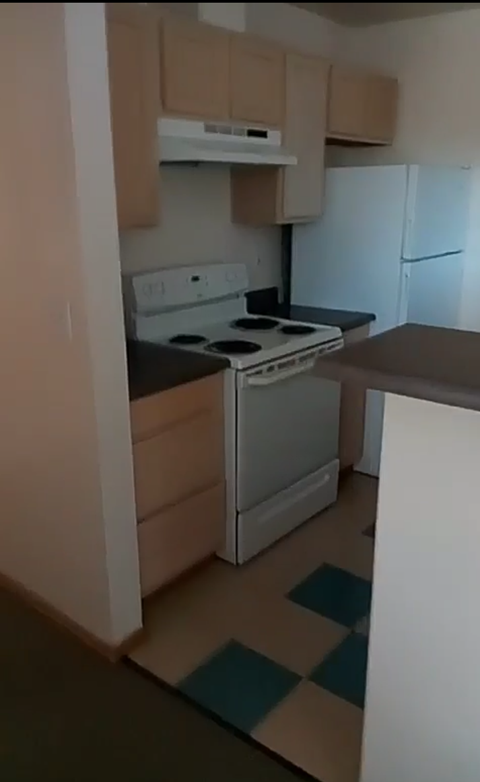 a kitchen with a stove and a refrigerator